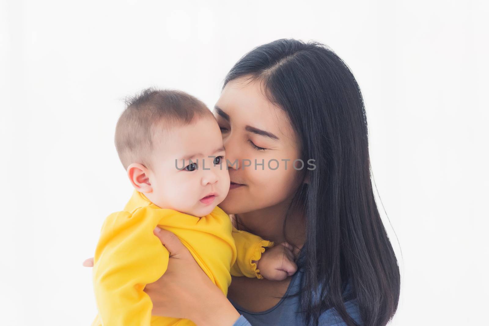 Portrait of beautiful young Asian mother holding his newborn little baby in her arms at home, Parent mom hugging her newborn child, happy family