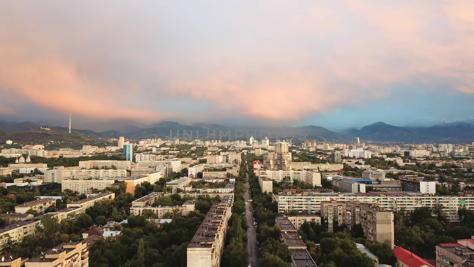 Bright color sunset over the city of Almaty. by Passcal