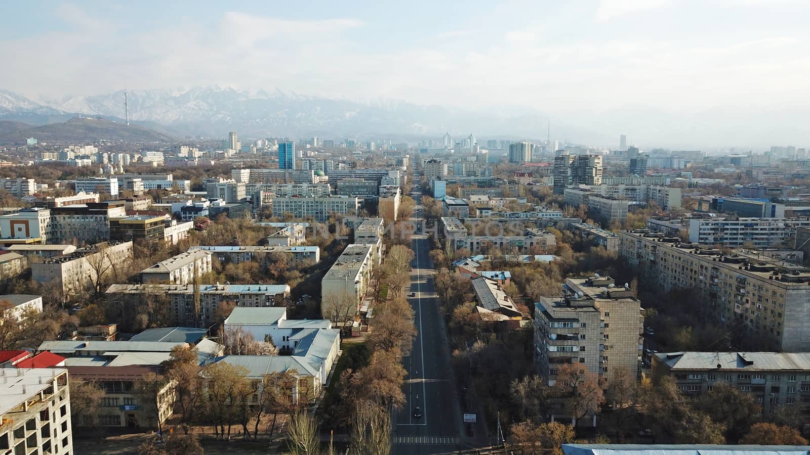 Spring city of Almaty during the quarantine period. Few people on the street, almost no cars. Transport is not running, and a strict quarantine has been imposed. Yellow trees without leaves.