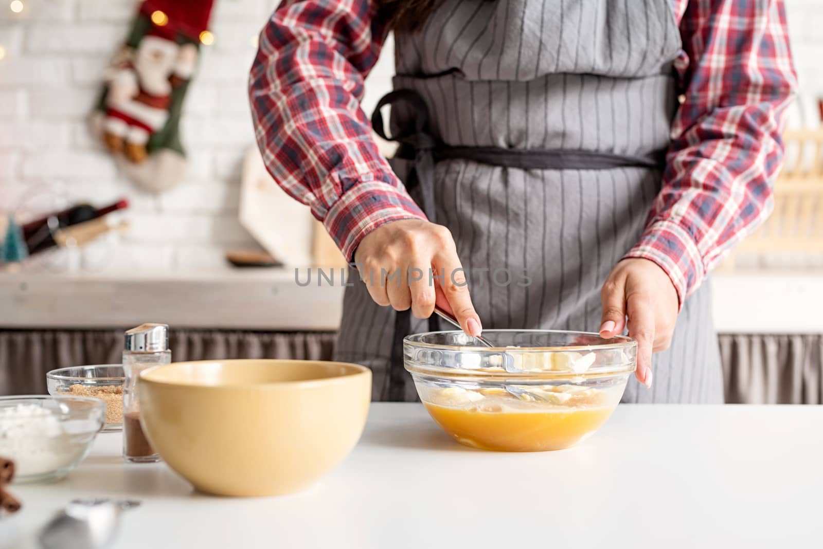 Young latin woman whisking eggs cooking at the kitchen by Desperada