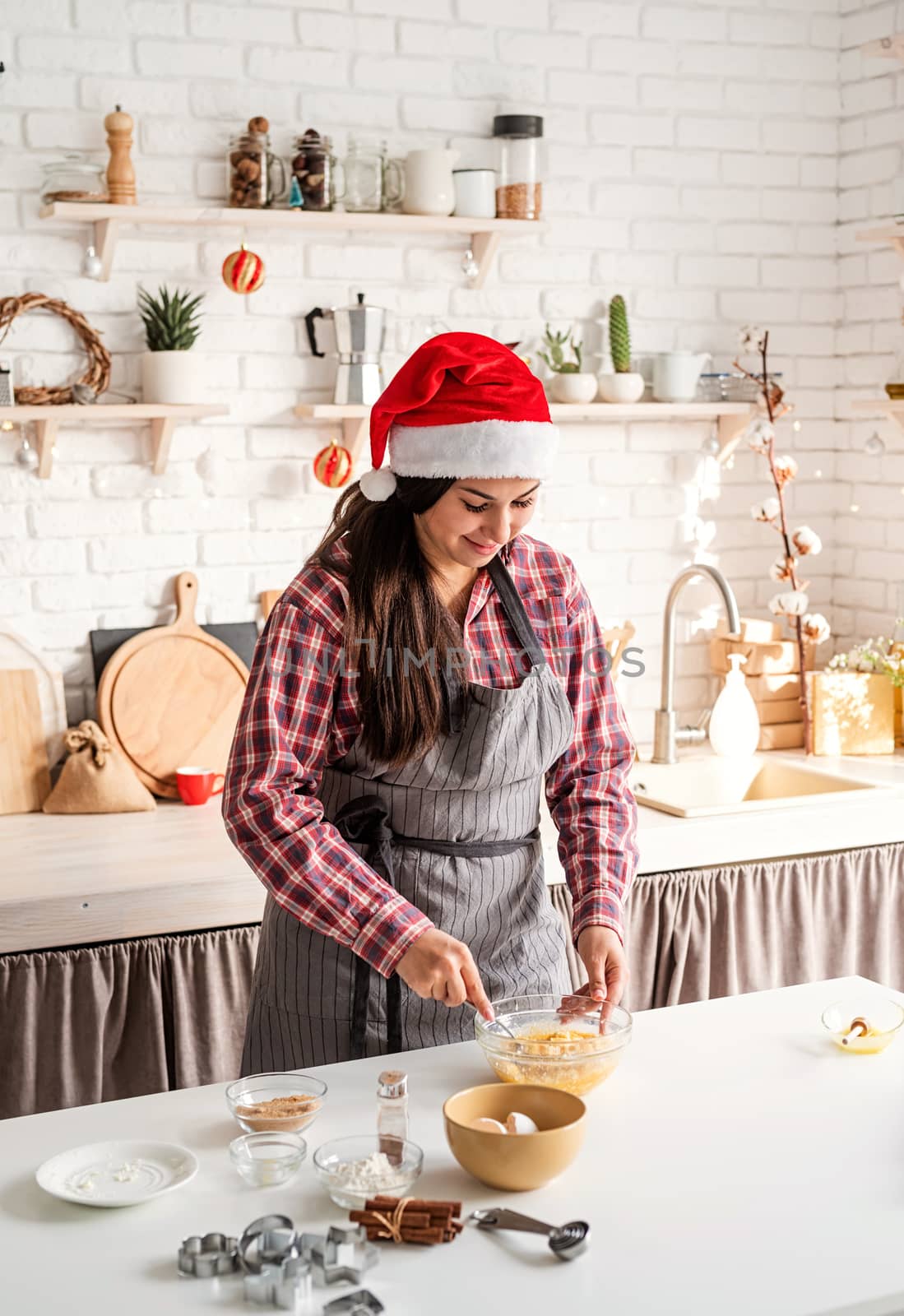 Cooking and baking. Young latin woman whisking eggs cooking at the kitchen