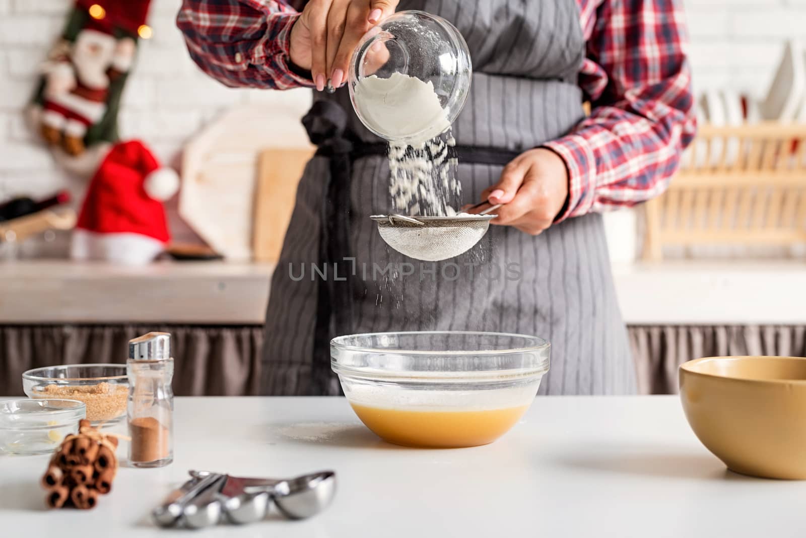 Cooking and baking. Young latin woman pouring flour to the dough cooking at the kitchen