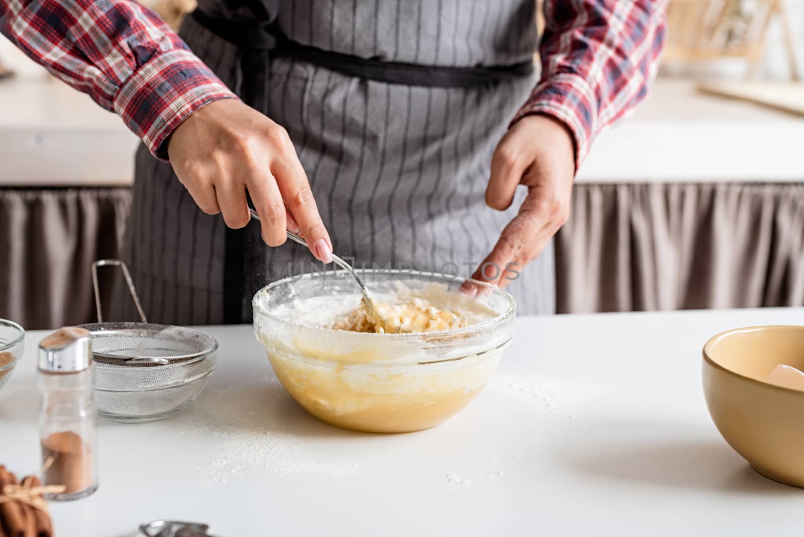 Young latin woman mixing dough cooking at the kitchen by Desperada