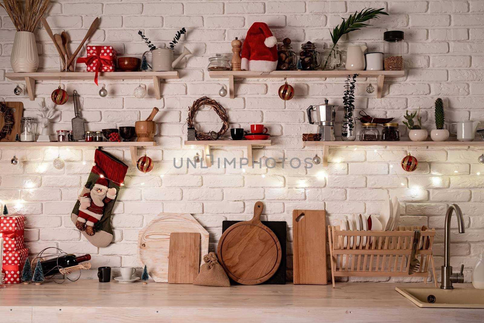 Interior light grey kitchen and red christmas decor. Festive kitchen in Christmas decorations, front view