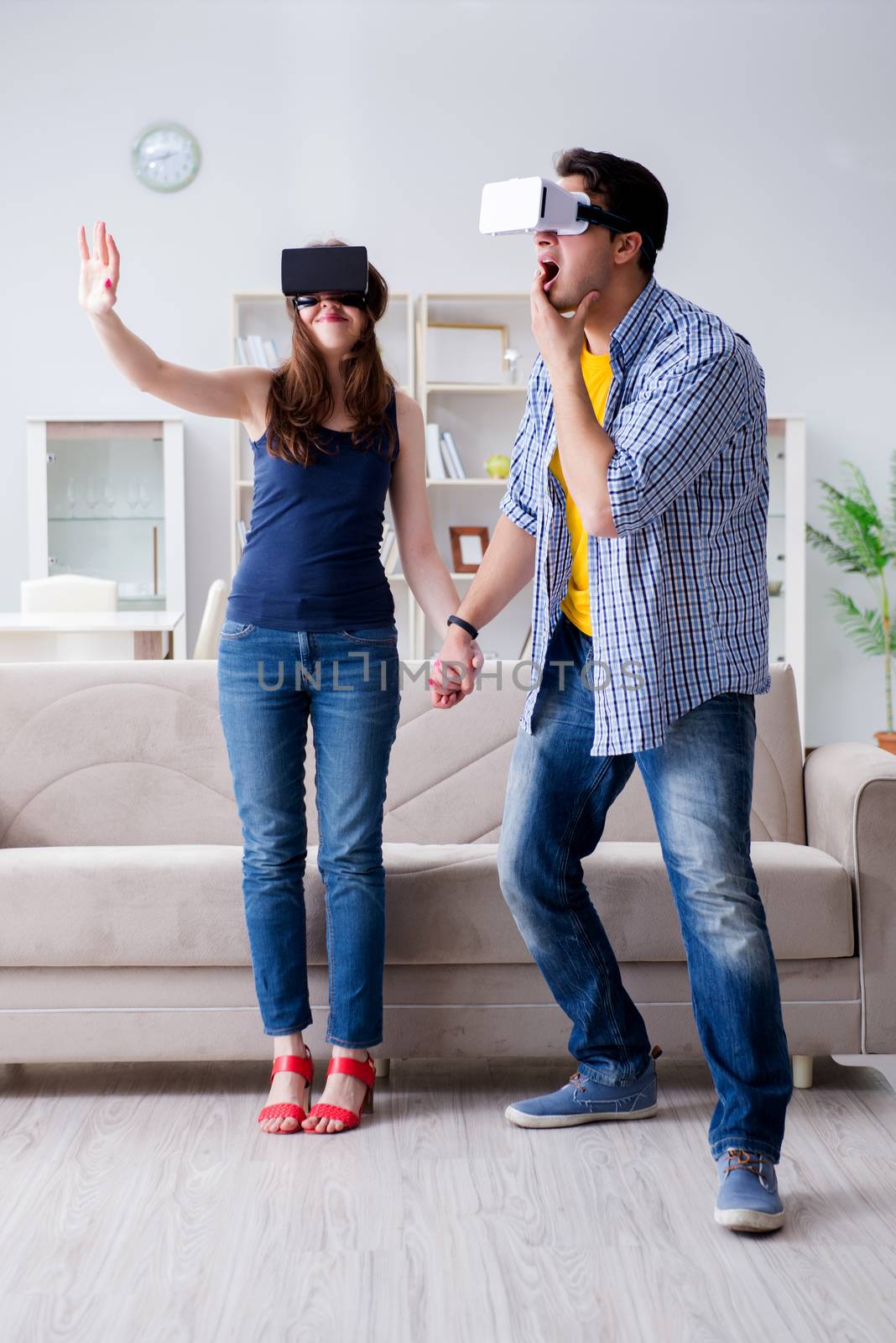 Young family playing games with virtual reality glasses by Elnur