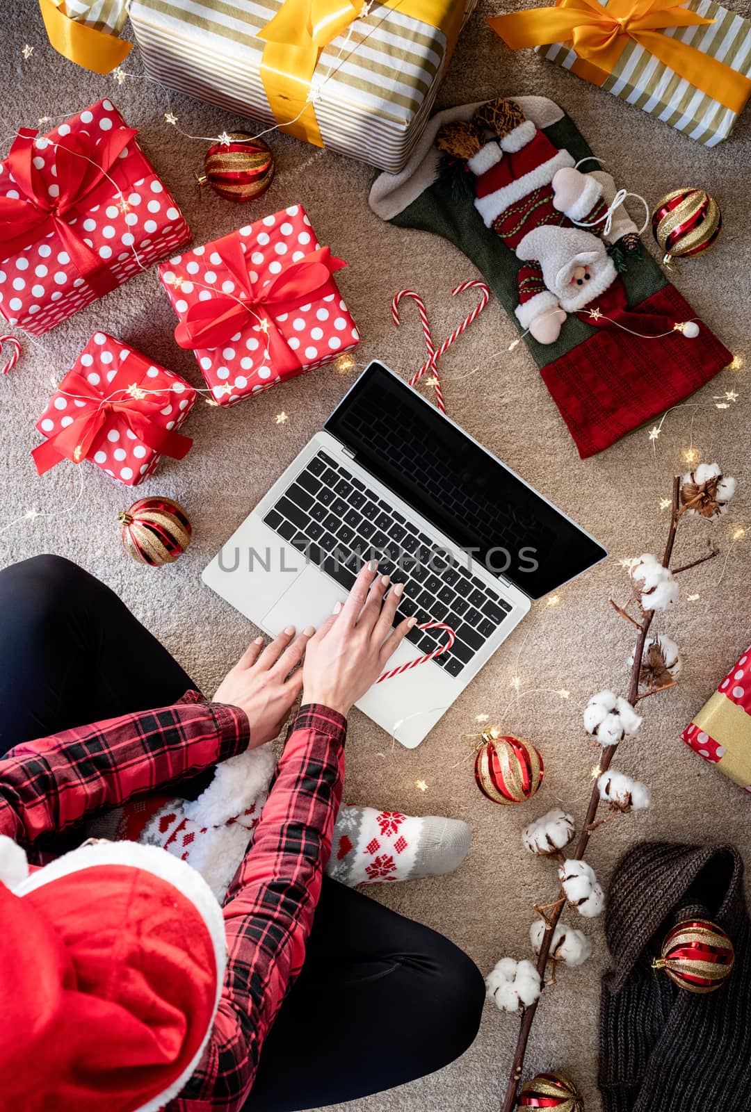 Top view of woman shopping online at christmas holidays holding a present. Christmas online shopping by Desperada