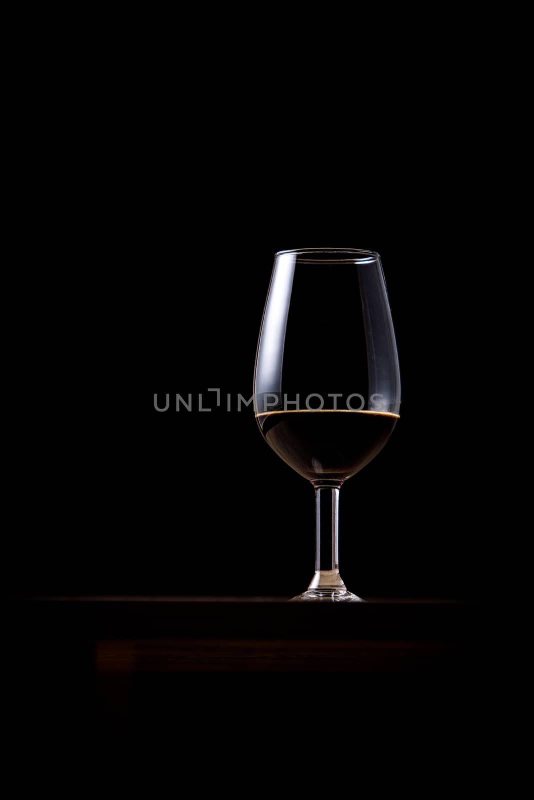 Dark beer in a glass on a dark background