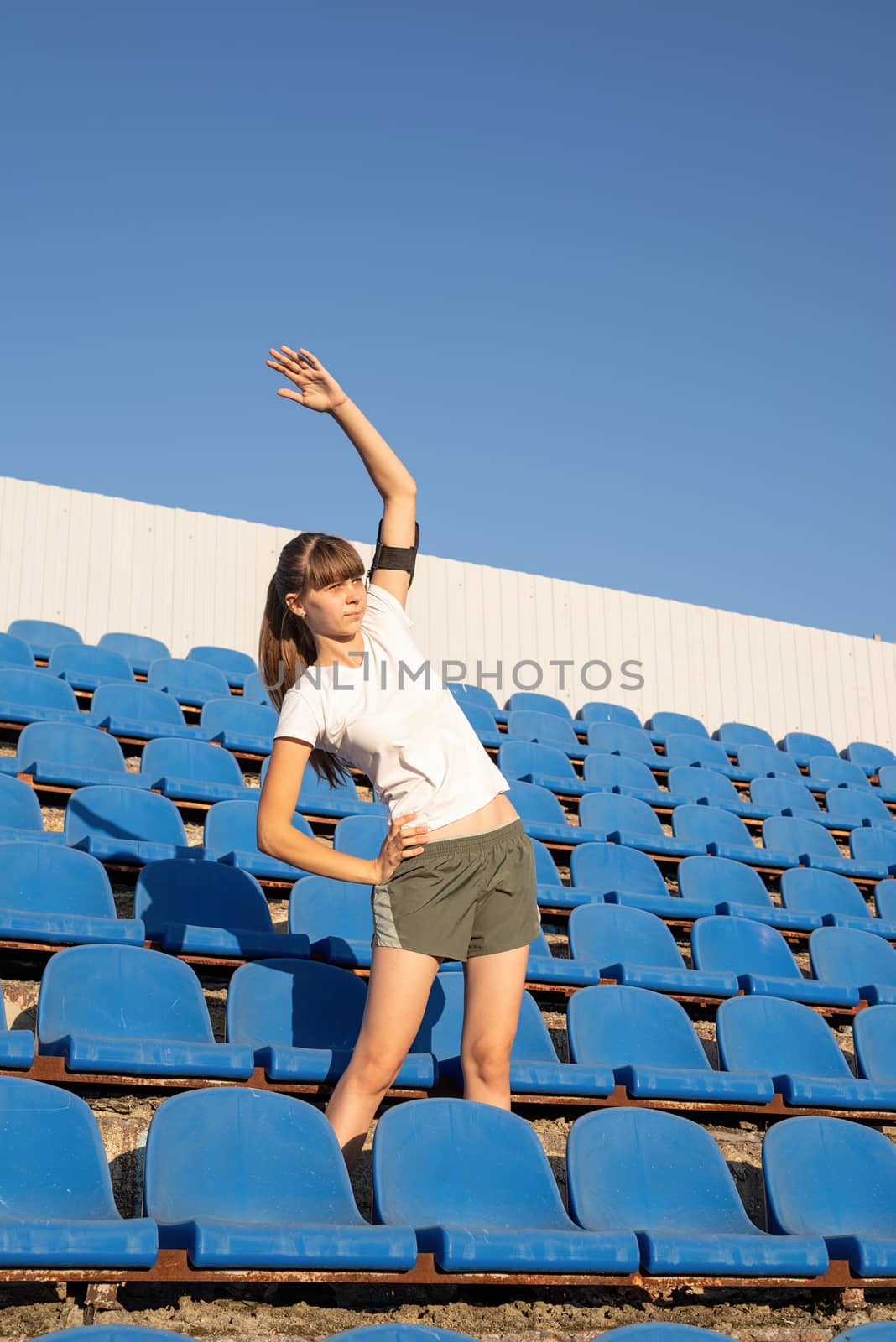 Healthy lifestyle concept. Teenage doing sports alone at the empty stadium