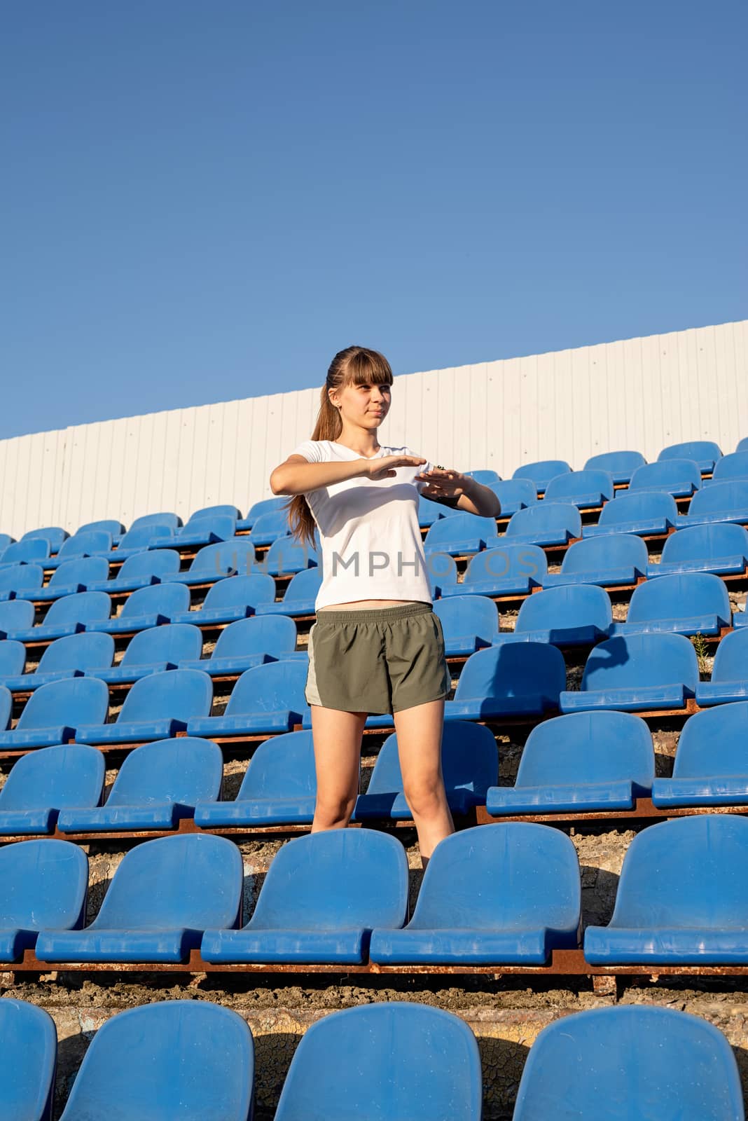 Healthy lifestyle concept. Teenage doing sports alone at the empty stadium