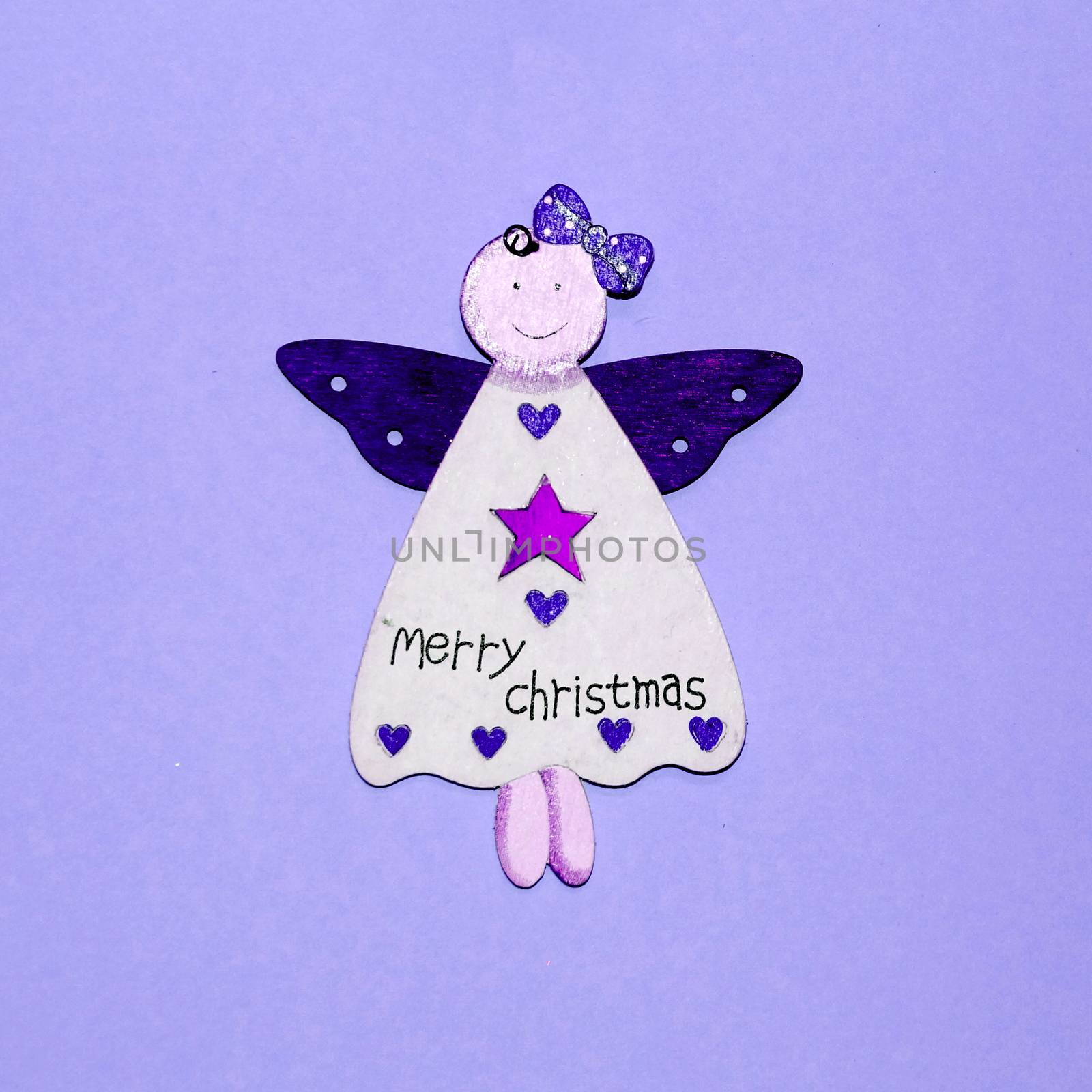 wooden angel with inscription on merry christmas dress on blue background by Annado