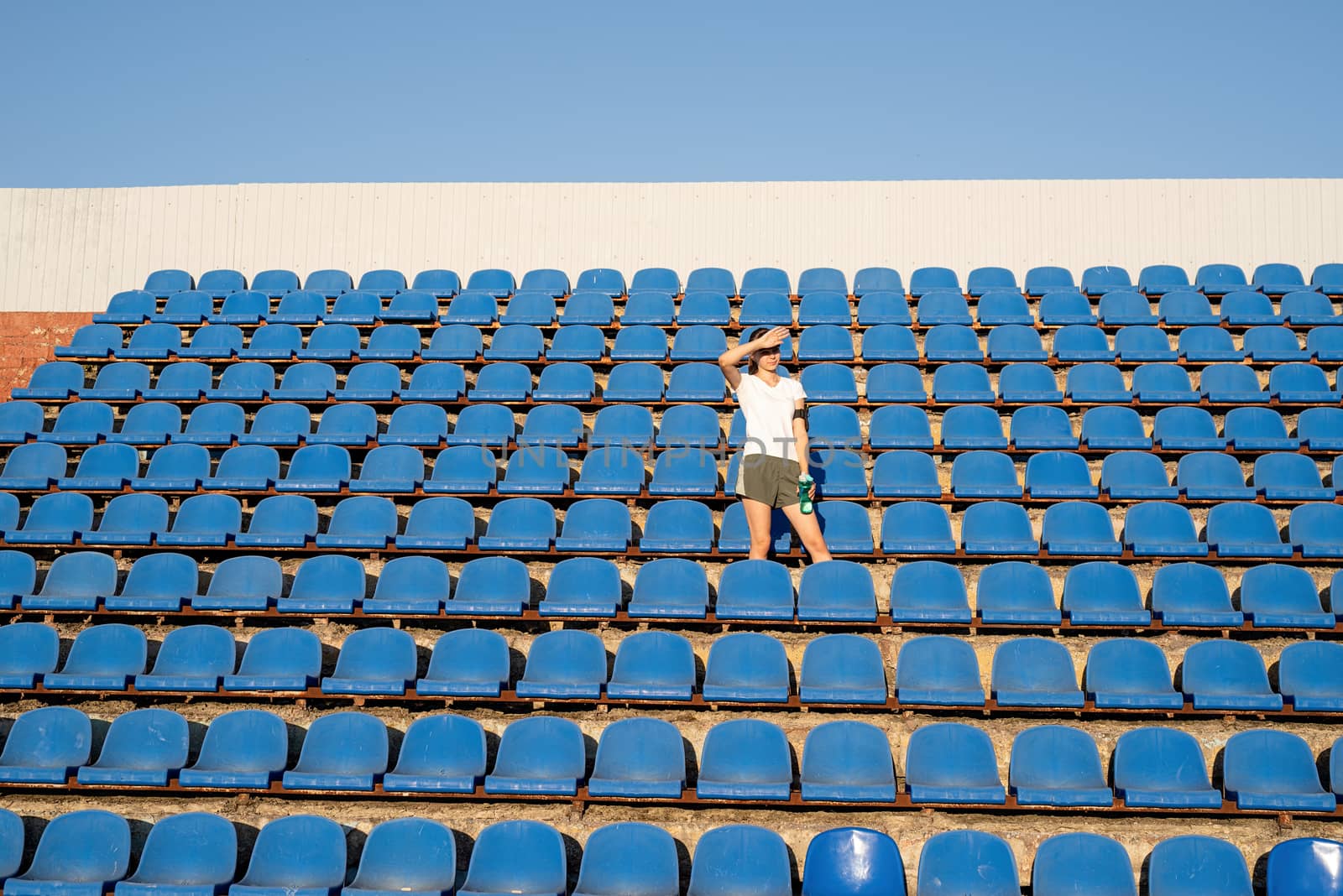 Healthy lifestyle concept. Teenage doing sports alone at the empty stadium