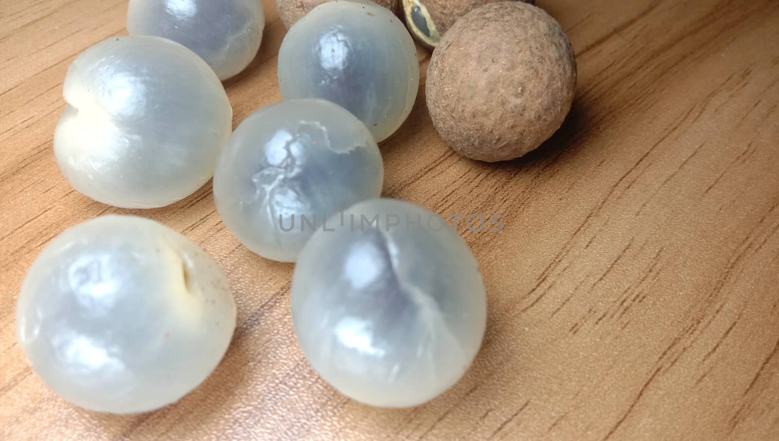 Tasty and Healthy Longan Stock on Wooden Table