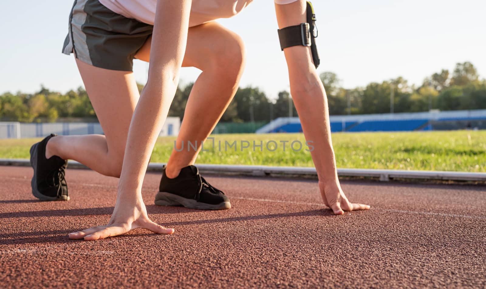 Young woman ready to race at stadium track by Desperada