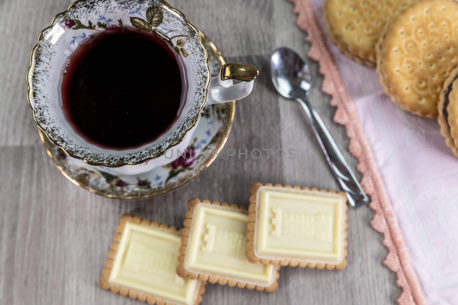 combination of food with tea and biscuits on a wooden table from above