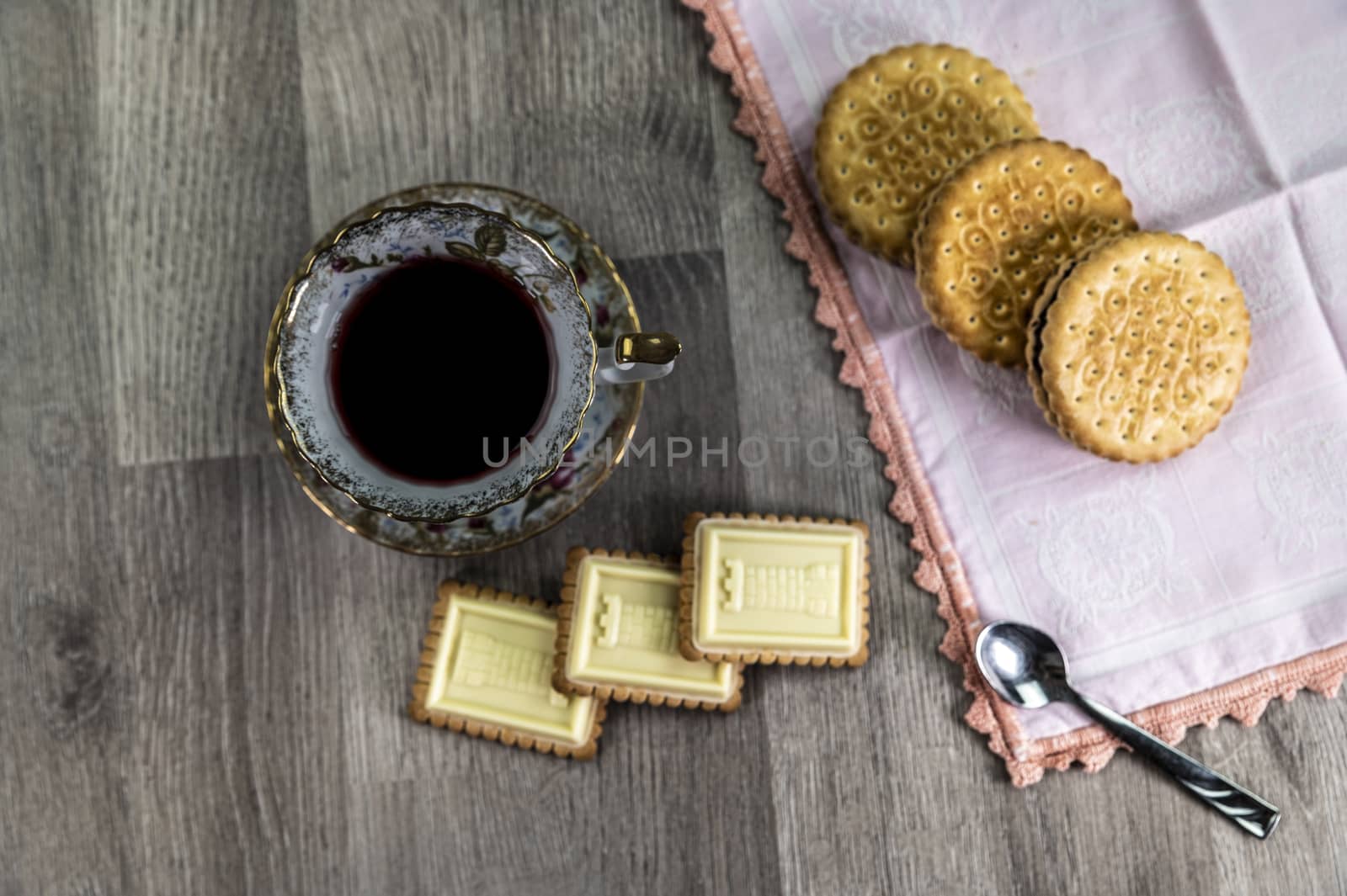 combination of food with tea and biscuits on a wooden table from above