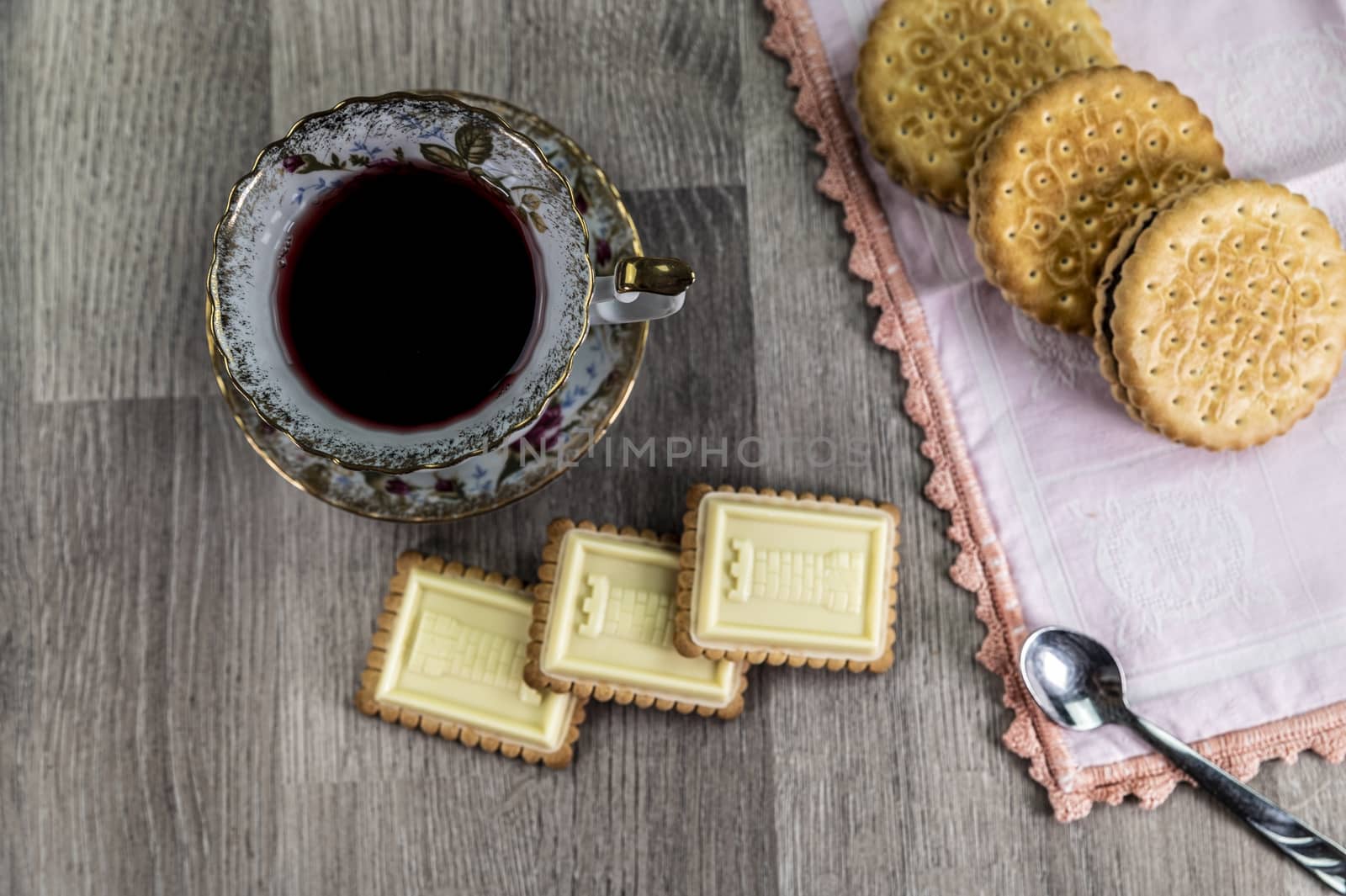 combination of food with tea and biscuits on a wooden table from above