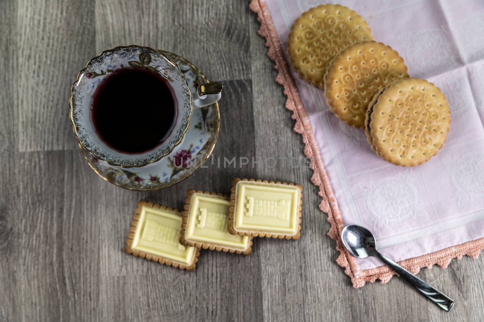 combination of food with tea and biscuits on a wooden table from above