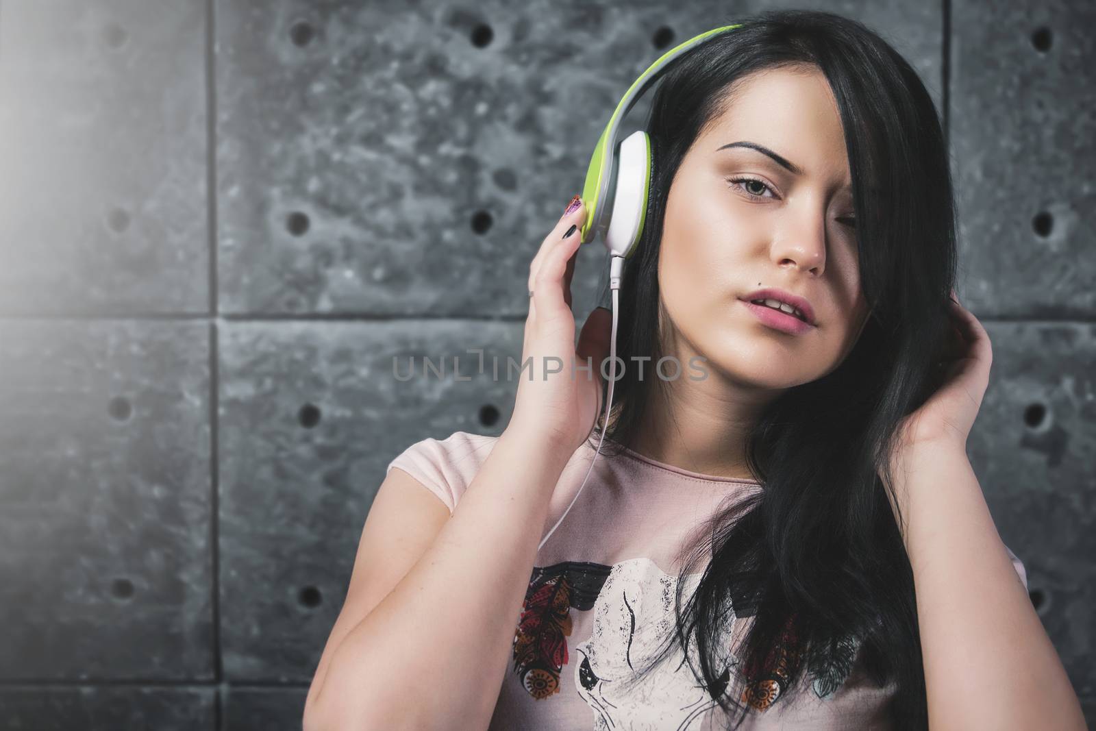 Sexy brunette with the headphones. music concept by Nickstock