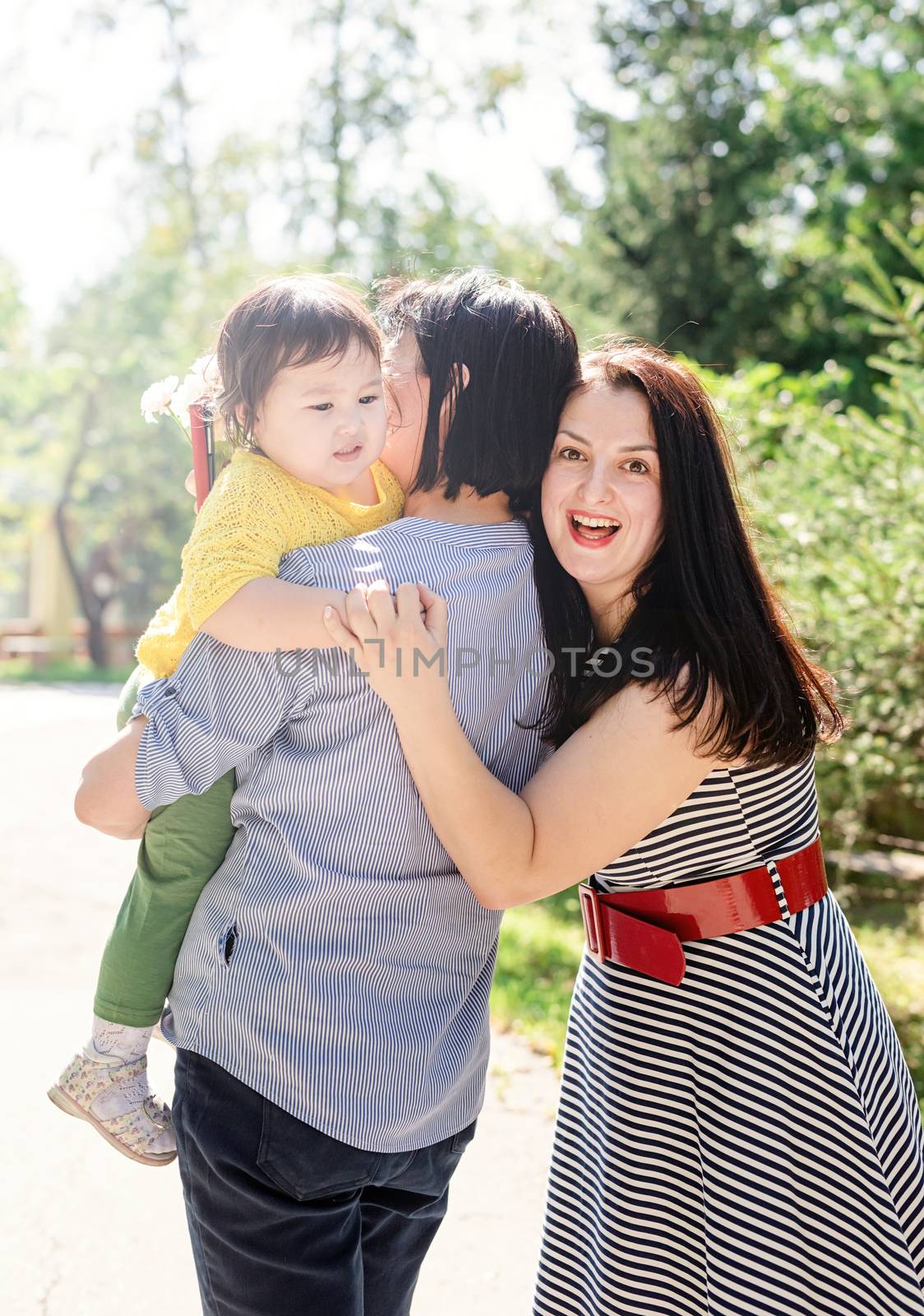 A multi generation portrait of a happy grandmother with her daughter and granddaughter by Desperada