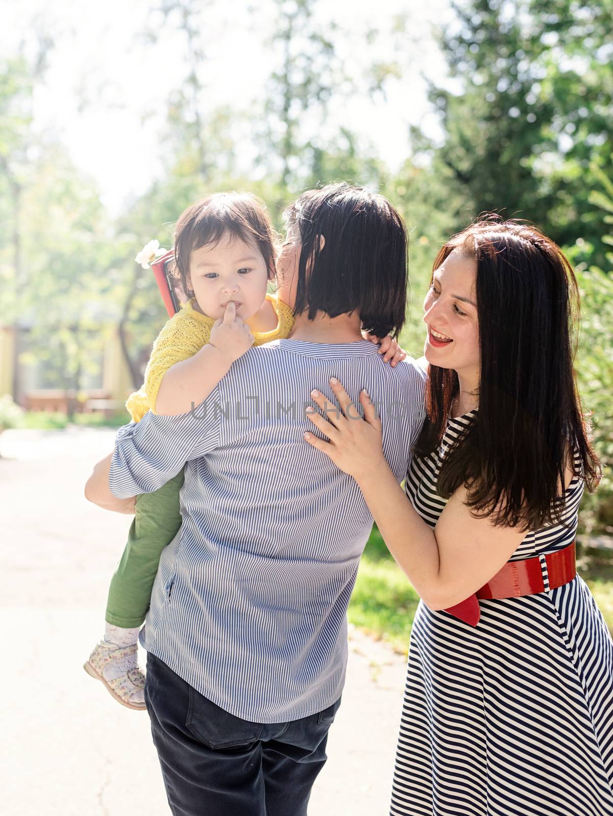 Multiethnic family. A multi generation portrait of a happy grandmother with her daughter and granddaughter