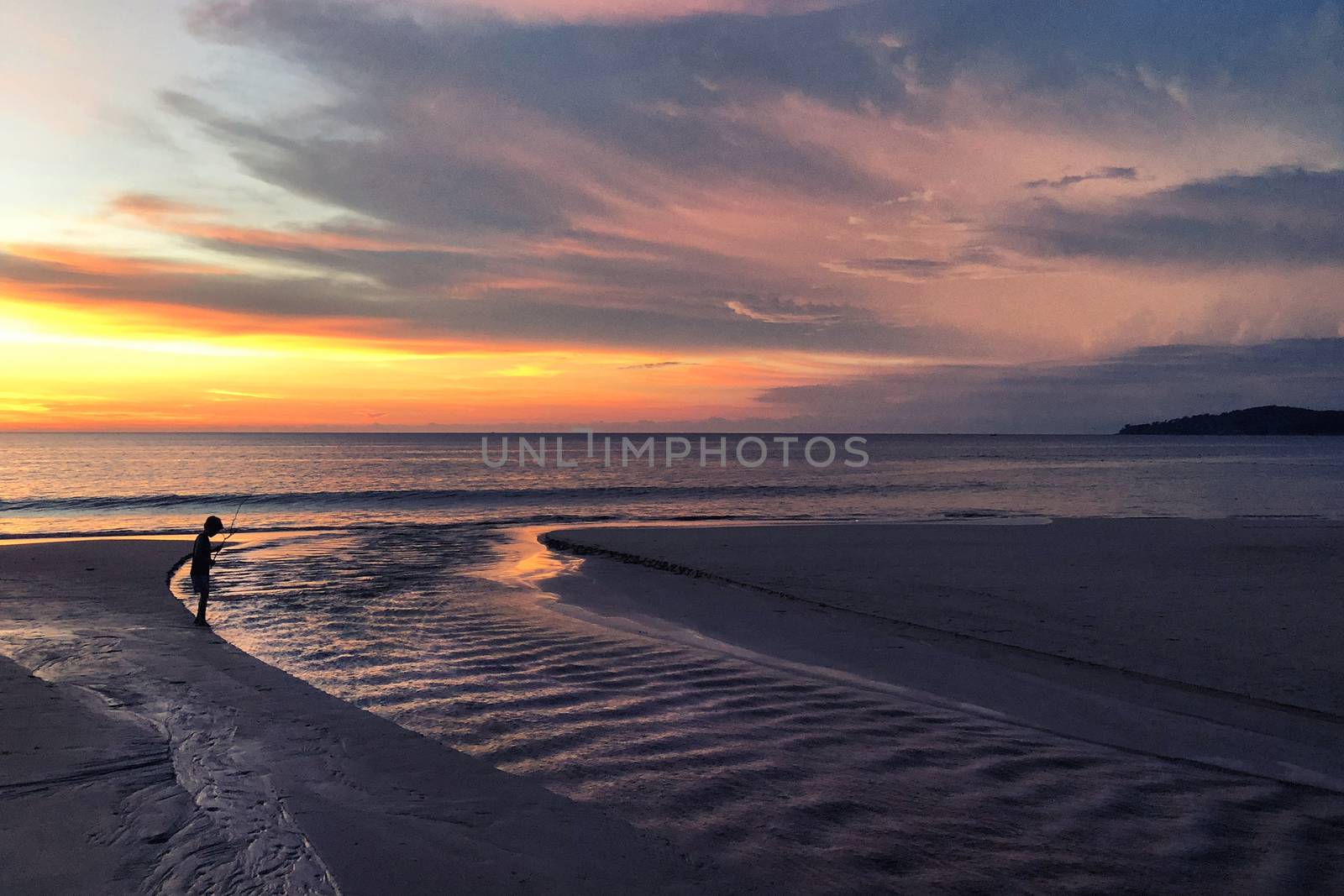 Panoramic view of sunset kid playing on the beach at Karon beach in Phuket, Thailand