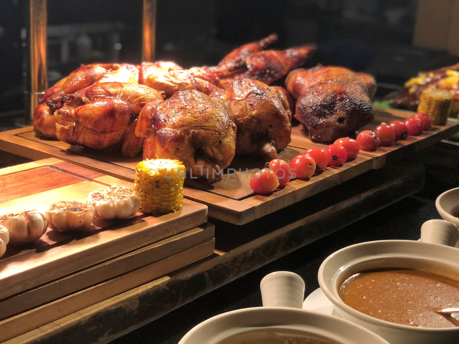 Roasted chicken with tomato and corn on wooden table