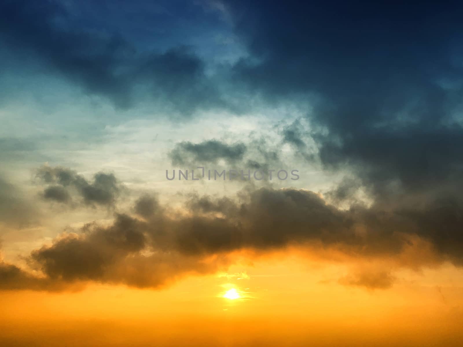 Skyscape of sunset view colors of orange and white clouds agains by Surasak