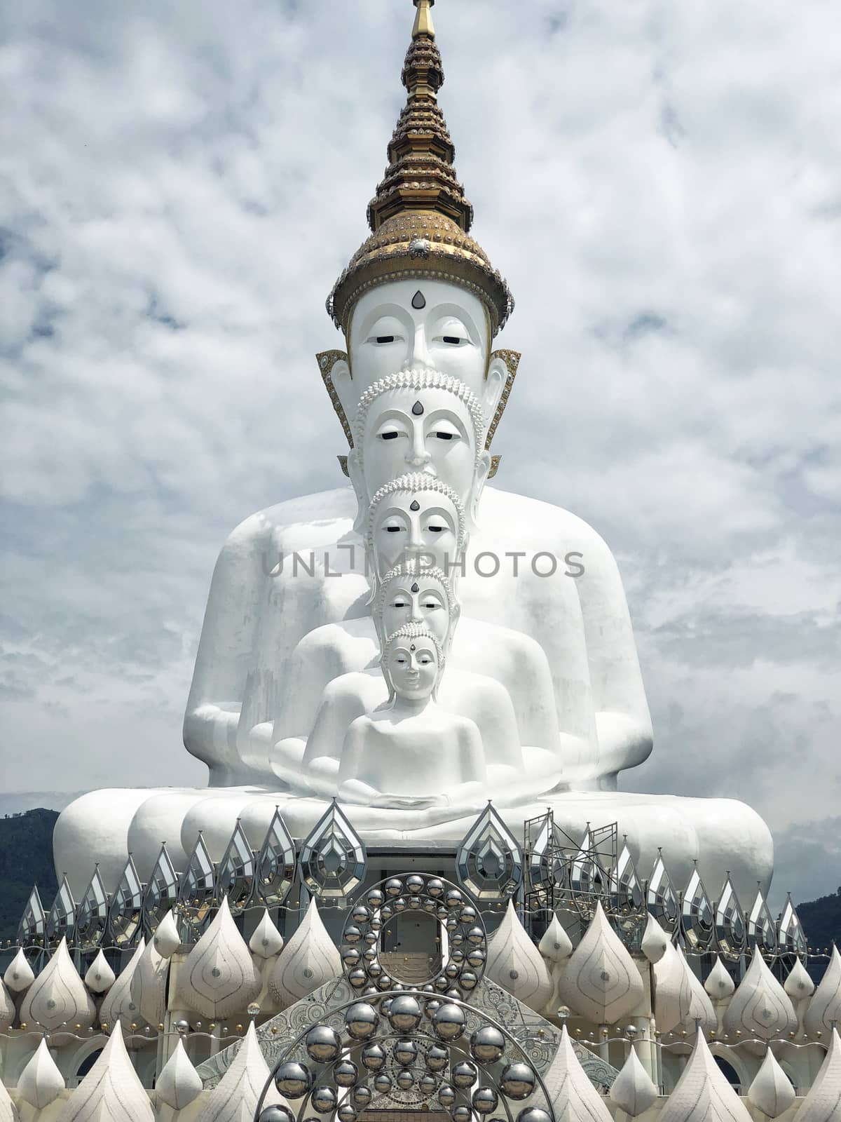 White Buddha Statue and cloud background at Wat Prathat Phasornk by Surasak