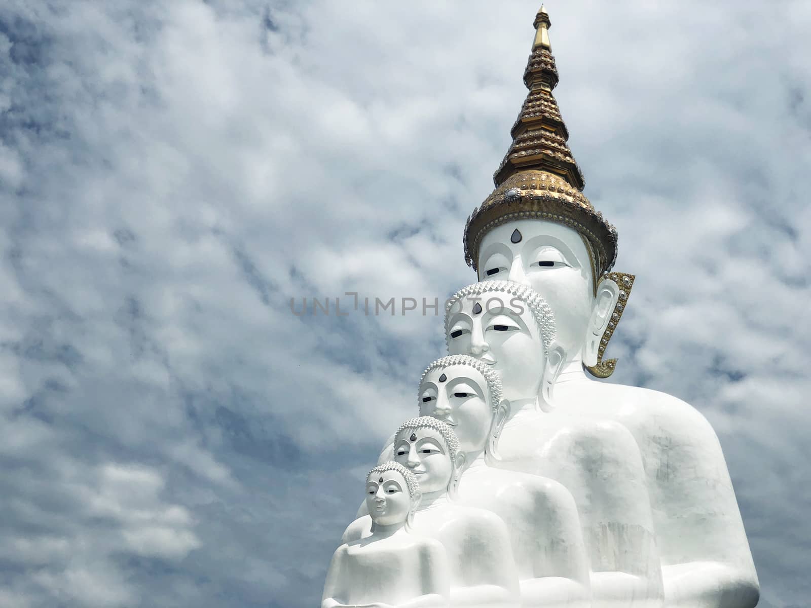 White Buddha Statue and cloud background at Wat Prathat Phasornk by Surasak