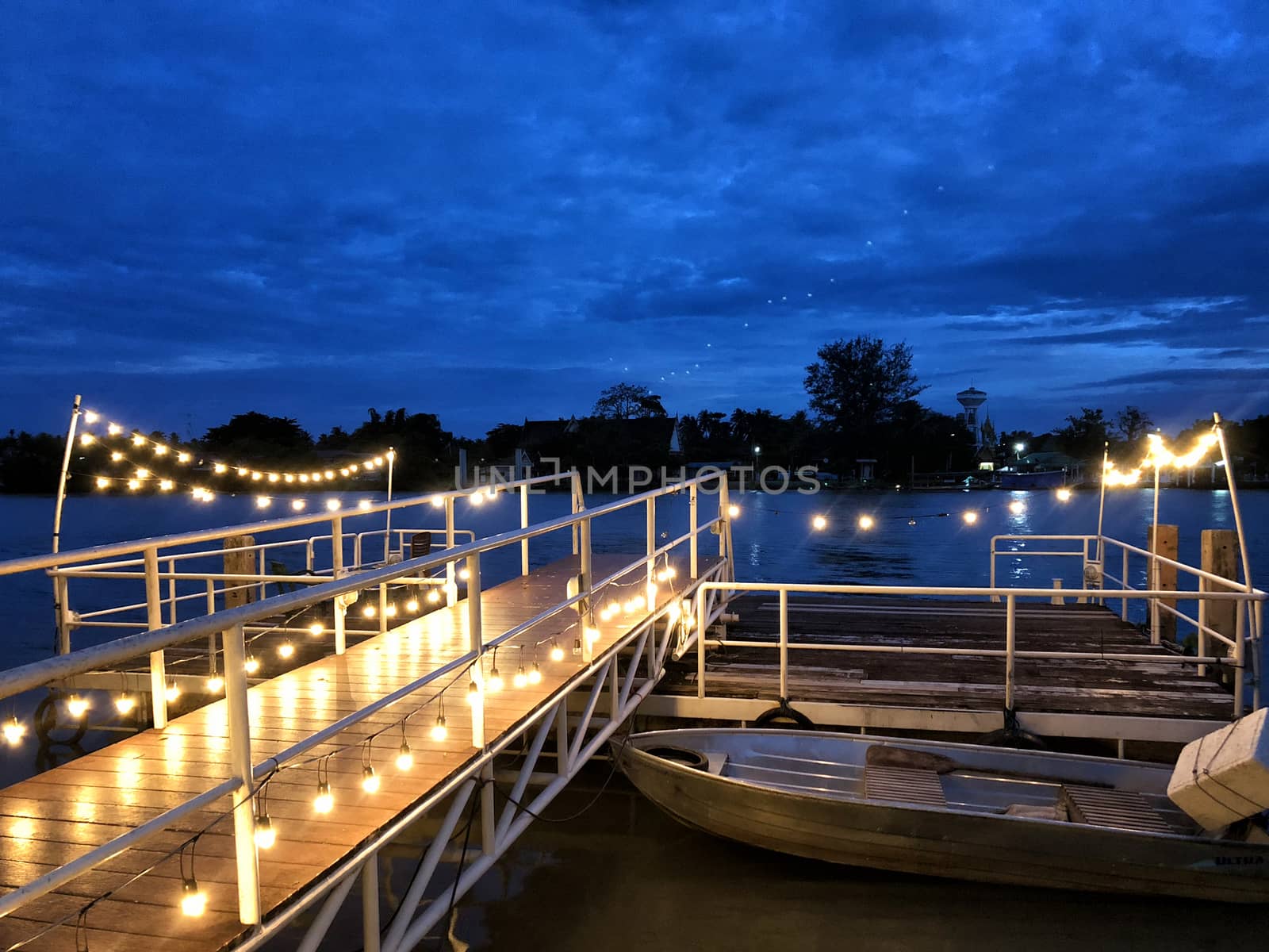 Wooden pier in Twilight beautiful sea with ship, view river and fishing boat of Mahachai Samut Sakhon Thailand