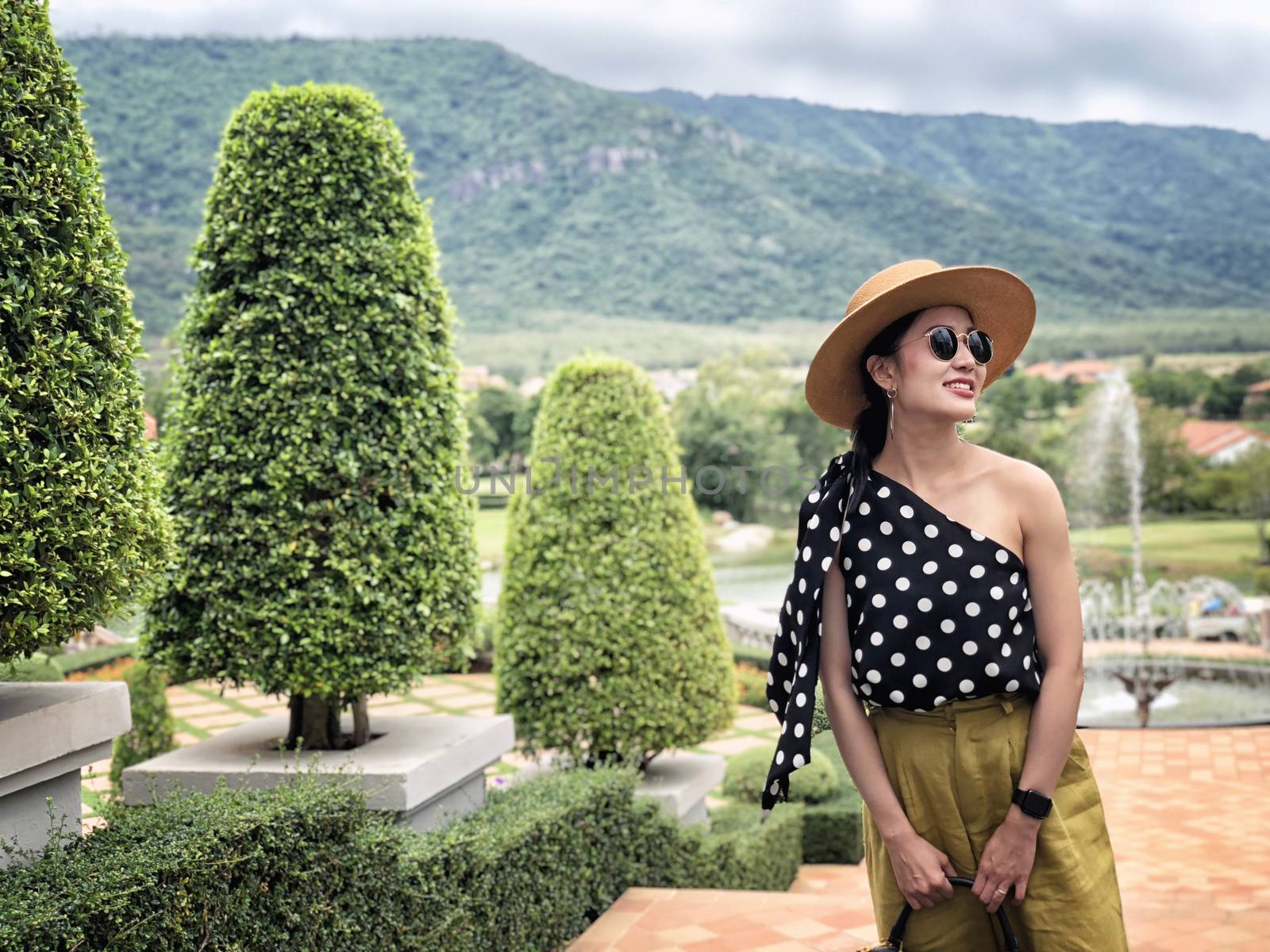 Woman wearing a planter panama hat visiting an Italian style vil by Surasak