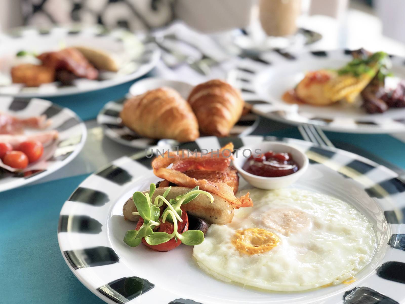 Delicious breakfast served with coffee, orange juice, egg, ham, bacon rolls at the luxury hotel