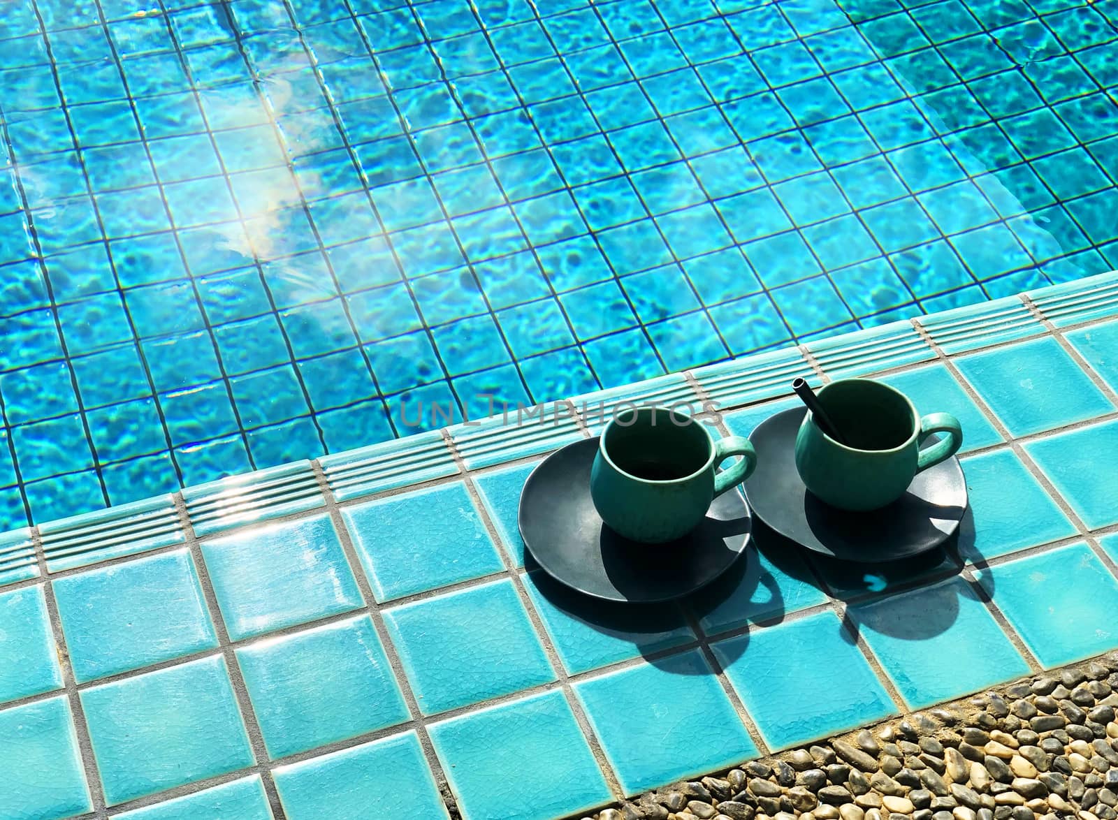 Two vintage cup of hot coffee  beside the pool. by Surasak