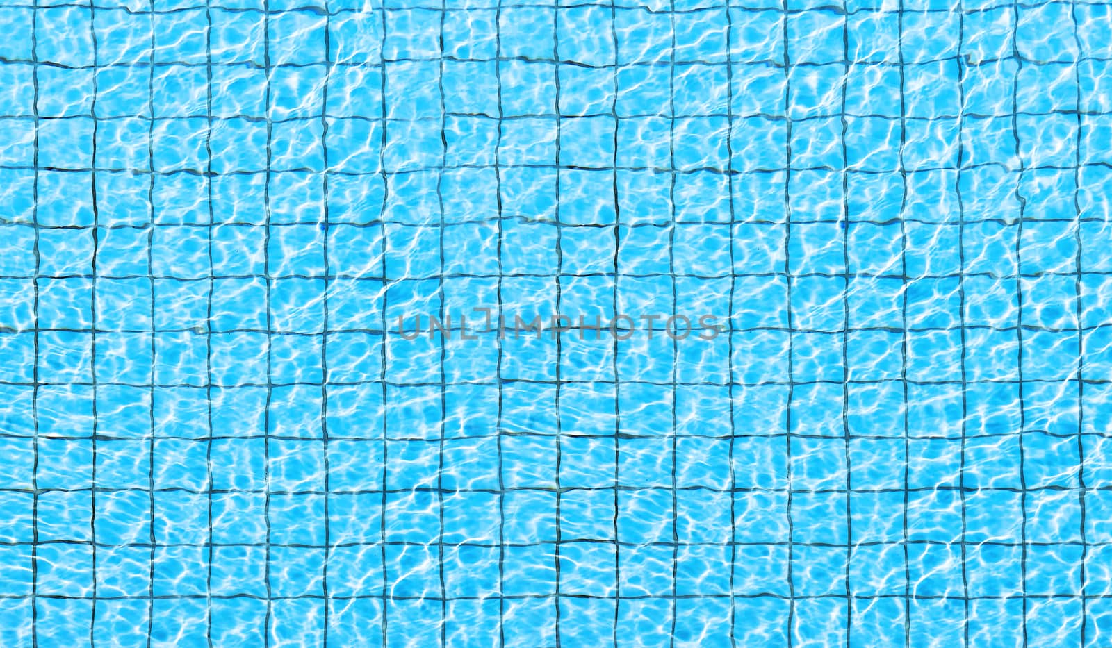 Top view of swimming pool bottom caustics ripple and flow with waves background. Summer background. Texture of water surface. 