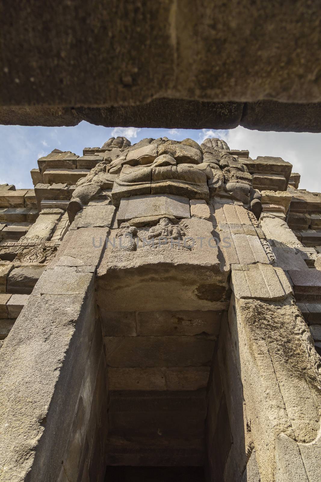 Huge carved stone face, in one of the shrines of the Prambanan ancient Hindu temple complex, Rara Jonggrang, in the Special, Yogyakarta region, Indonesia.