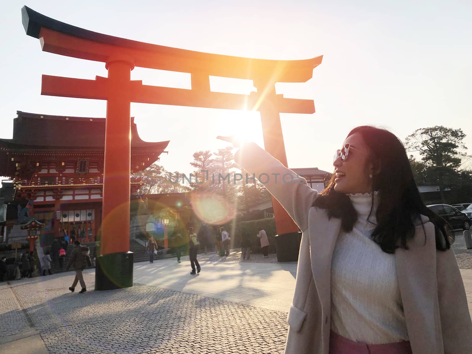  Young woman tourist travel Kyoto, Japan at Fushimi Inari Shrine main gate at sunrise