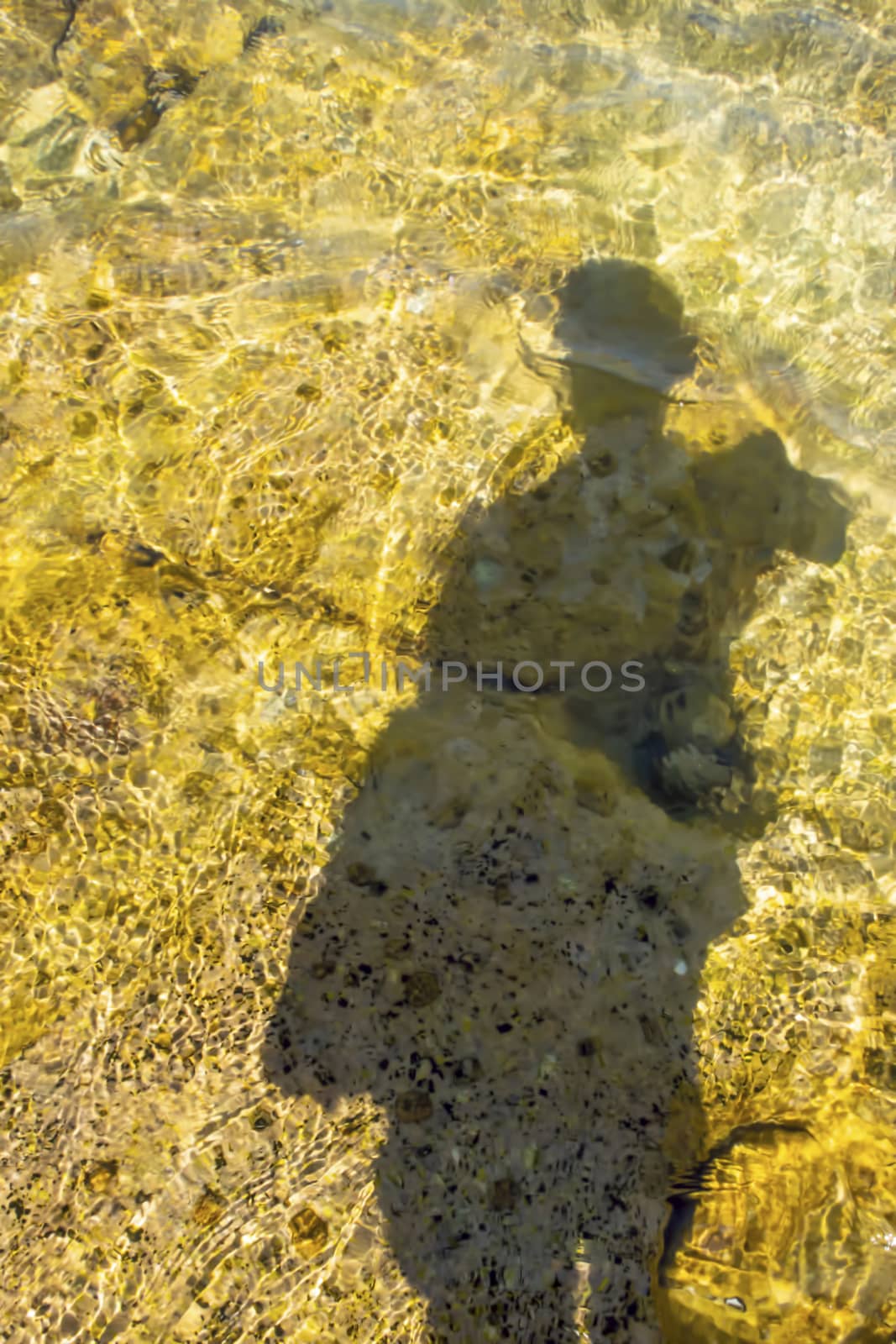 human shadow on the sea shore and in the water by yilmazsavaskandag