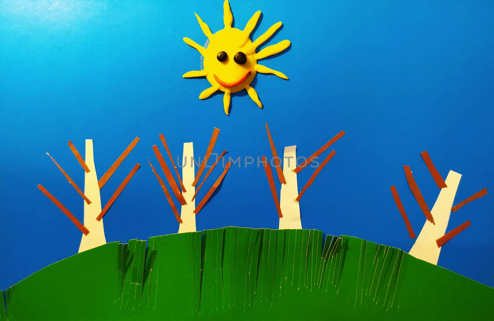 Illustration of the sun with trees on a green hill against a blue sky made of paper strips. by Igor2006