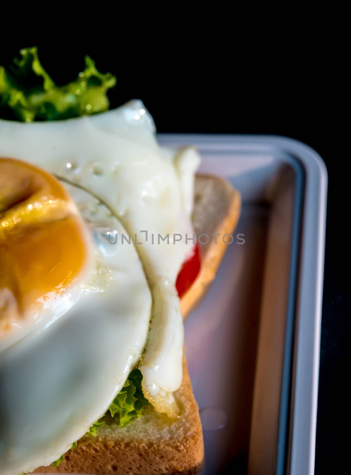 Fried egg and vegetable on sandwich bread by Satakorn