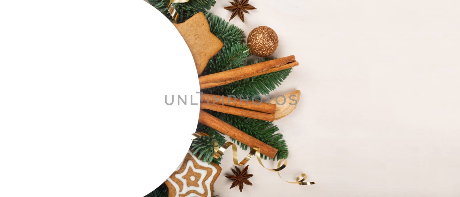 Christmas circle frame of natural fir tree branches and gingerbread cookies with copy space for text