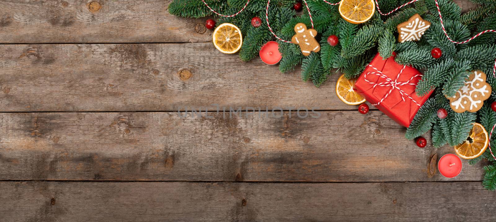 Christmas or New Year background composition made of Xmas decorations gingerbread cookies and fir tree branches and gift with copy space for text