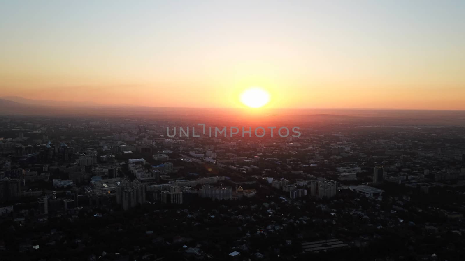 Red sunset over the city of Almaty. by Passcal