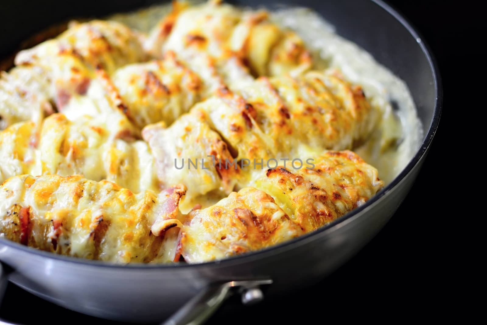 Baked Crispy Croque Monsieur Hasselback Potatoes Stuffed With Bacon, Cheese, Covered With Bechamel Sauce In Pan.