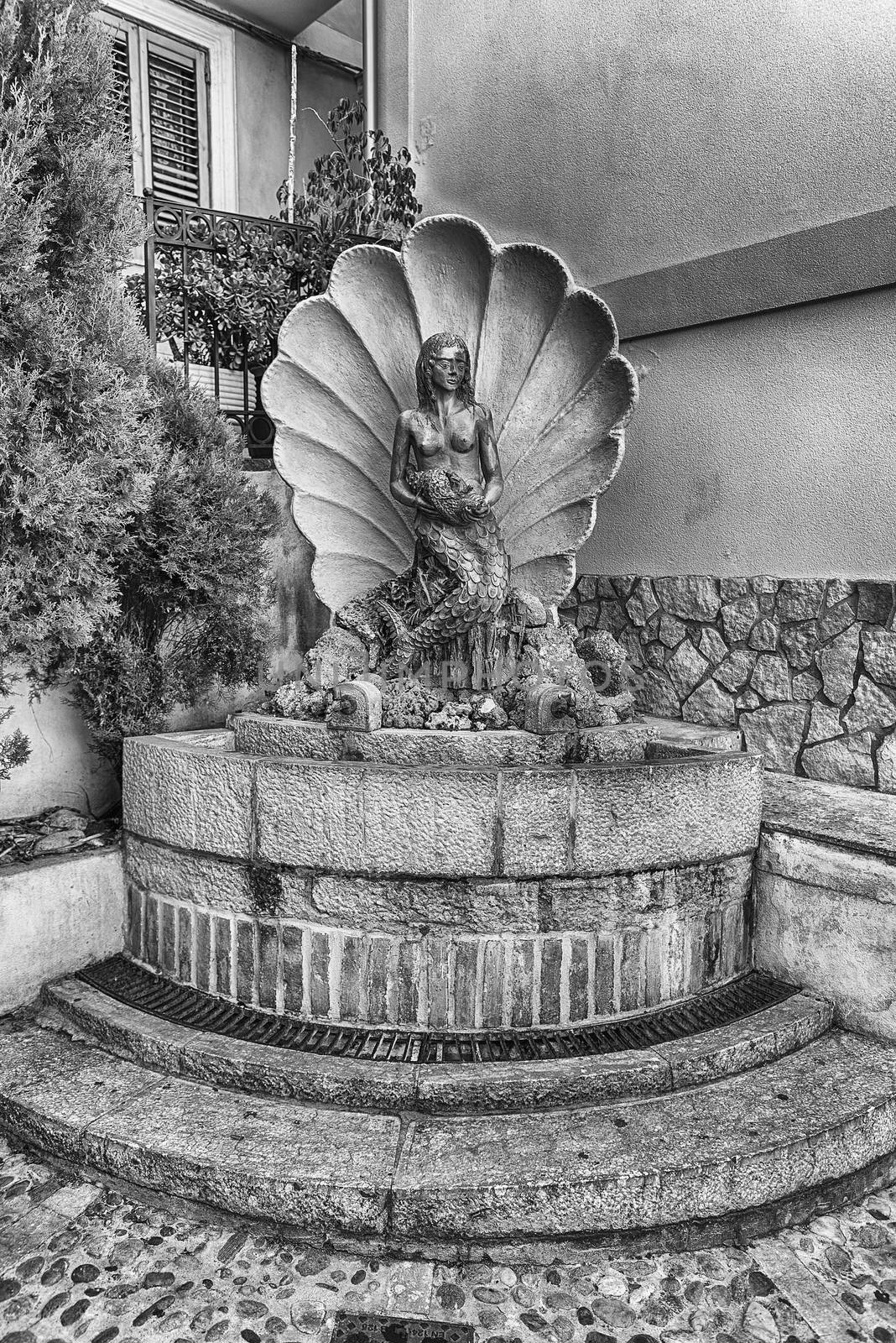 Scenic fountain in the seaside village of Chianalea, fraction of Scilla, Calabria, Italy