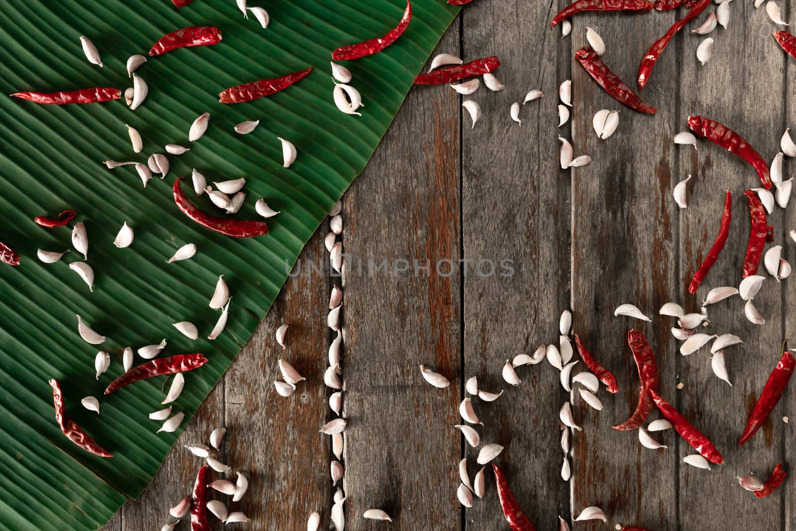 Fresh red chili and garlic with pepper seeds on wooden background