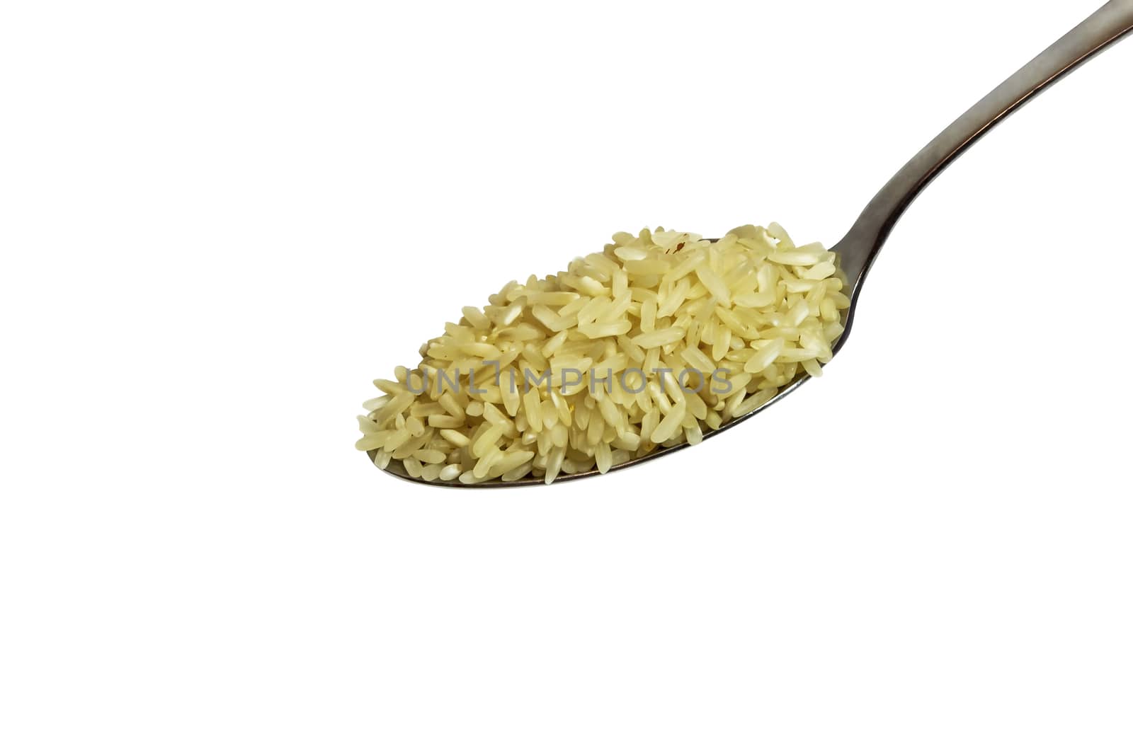 Rice croup in a metal spoon on a white background
