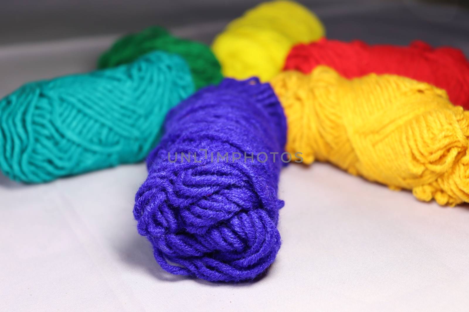 multiple colored yarn stock on white background