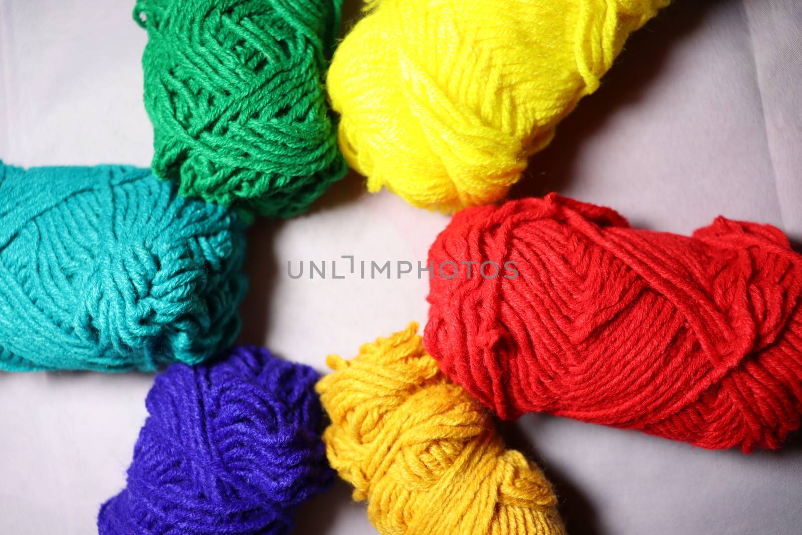 multiple colored yarn stock on white background