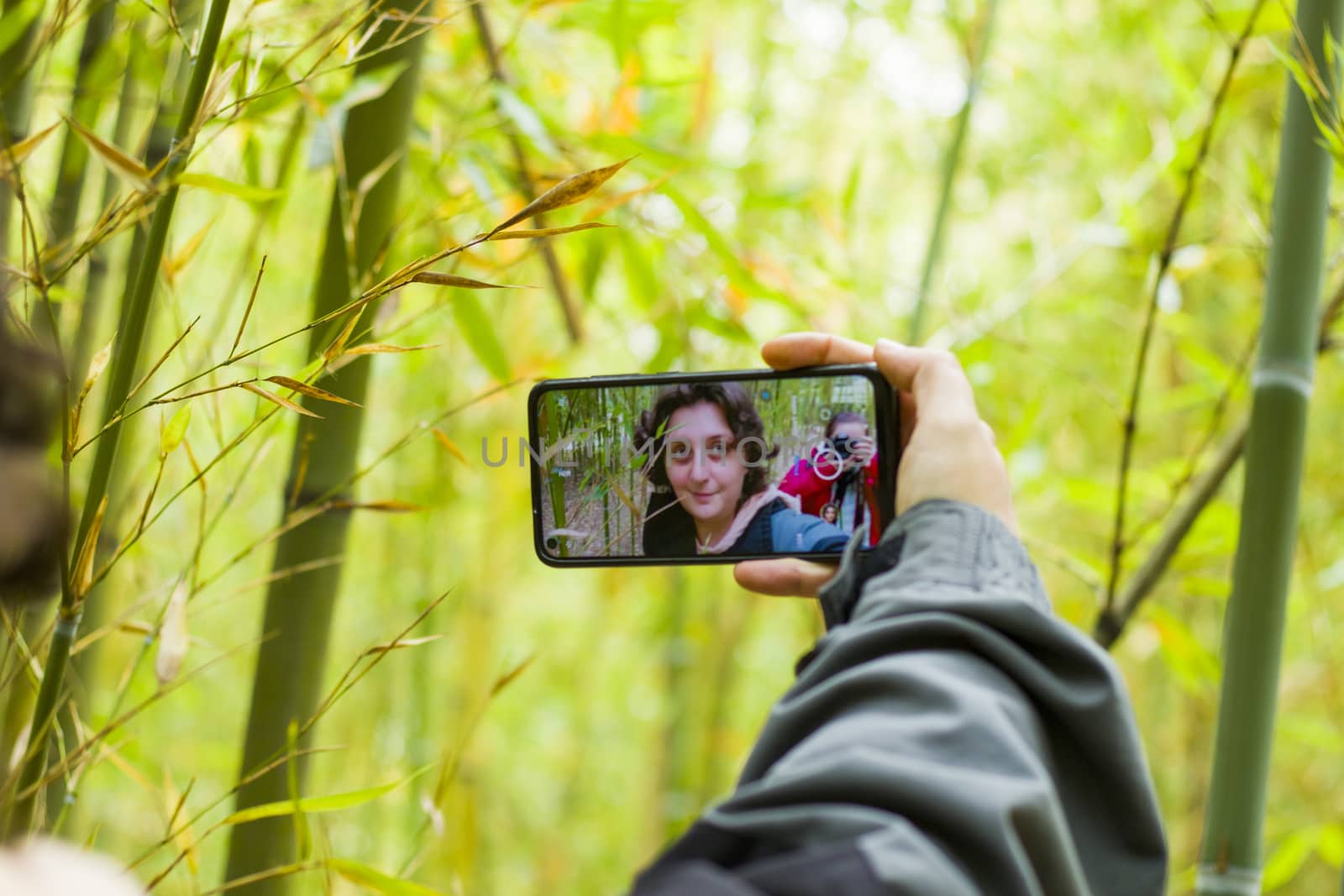 Kakheti, Georgia - November 12, 2020: Woman takes self photo, mobile phone and nature background