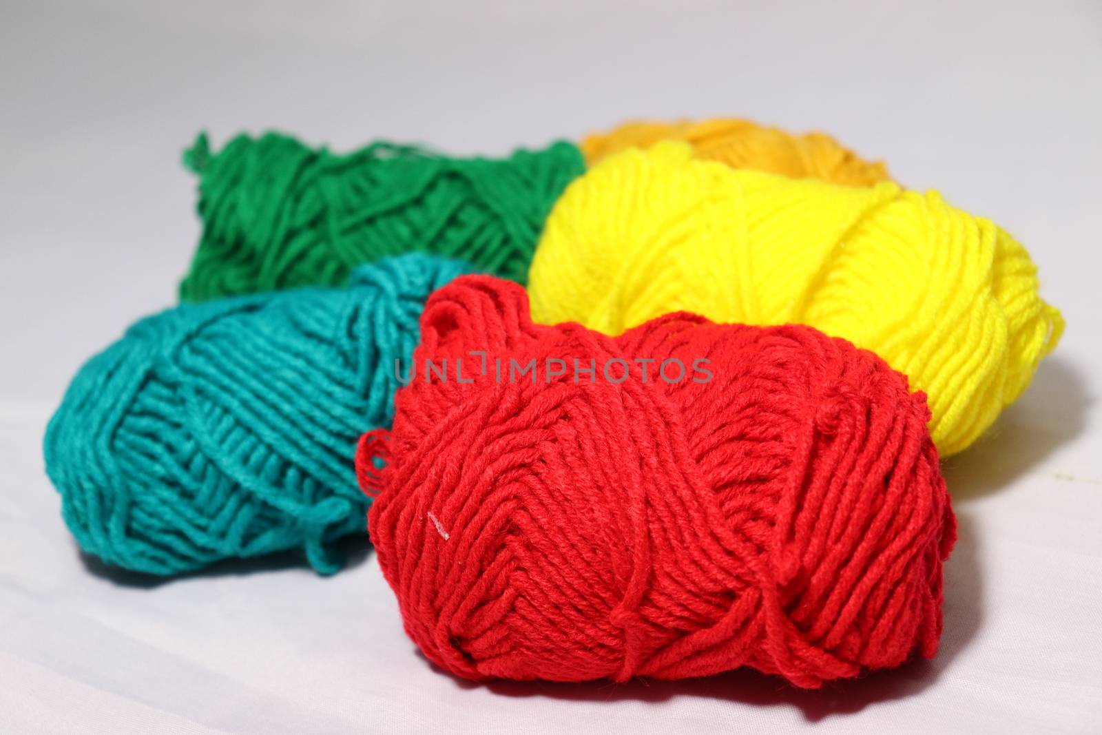 multiple colored yarn stock on white background